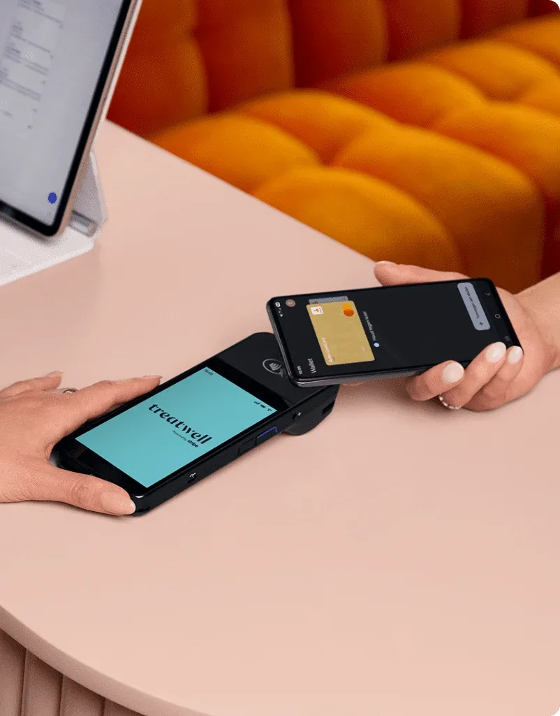 Treatwell POS terminal taking a contactless payment at the salon counter